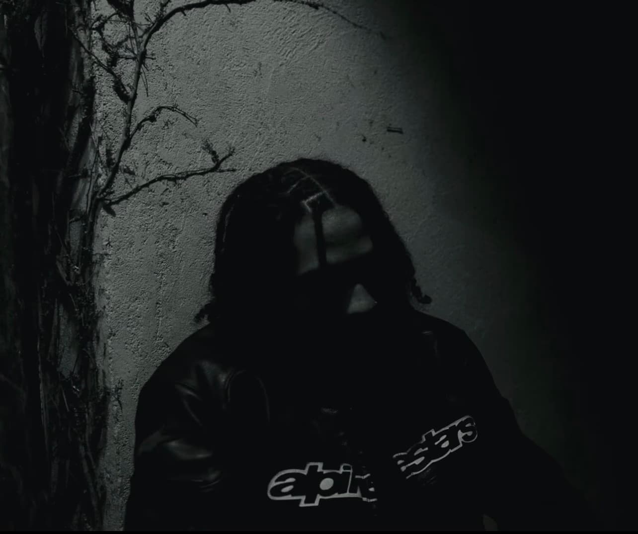 Continuity - figure against vine wall